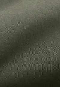 Textured, dark olive green fabric showcasing a smooth, soft finish with a subtle, consistent ribbed pattern throughout.