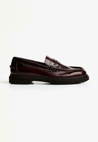 Brown leather loafers with a rounded toe, decorative stitching, and a low black rubber sole. Smooth finish with slight shine.