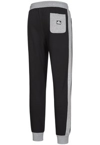 Svarta sweatpants med gråa detaljer längs sidorna och en bakficka med ett märke. Elastiskt midjeband och muddar för komfort.