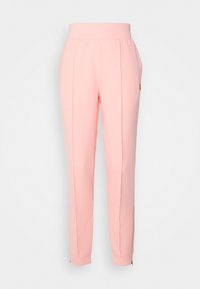 Rosa träningsoverallsbyxor med en bred elastisk midja, avsmalnande ben, sidosenor och dragkedjor vid anklarna. Tillverkade av ett mjukt, stretchigt material.