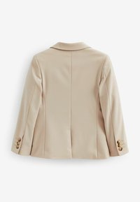 Beige kavaj med en strukturerad silhuett, slagkrage och tre-knapps detaljer vid ärmen. Slät tyg med en ren bakseam.