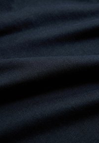 Dark navy blue fabric with soft, slightly wrinkled texture and fine woven pattern visible in close-up view.