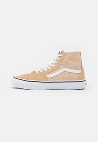 High-top sneakers featuring a tan suede and canvas upper, white laces, and a black rubber sole with white accents.