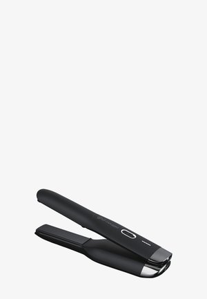 Lisseur de cheveux sans fil noir avec un bouton d'alimentation et un indicateur LED sur le dessus, légèrement ouvert sur un fond blanc.