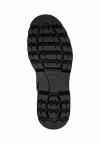 Semelle en caoutchouc noir avec de profonds motifs, détail de logo circulaire, empreinte de taille 37 et surface supérieure lisse. Conçu pour l'adhérence et la durabilité.
