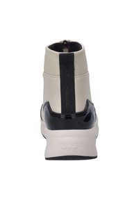 Wysokie sneakersy z beżowej skóry i akcentami z czarnej lakierowanej skóry, z logo z tyłu i zamkiem błyskawicznym z boku dla łatwego zakładania.