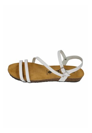 White strappy flat sandal with three front straps, ankle buckle, cork sole, and tan suede footbed.
