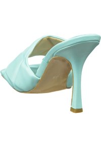 Pantof cu toc înalt de culoare albastră acvatică, cu vârf ascuțit și spate deschis. Material din piele netedă și toc stiletto subțire. Talpă de nuanță bej deschis.