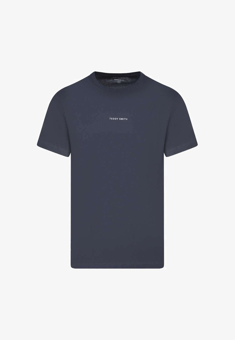 T-shirt bleu marine à manches courtes avec col rond, portant l'inscription "TEDDY SMITH" en petites lettres blanches centrées sur la poitrine.