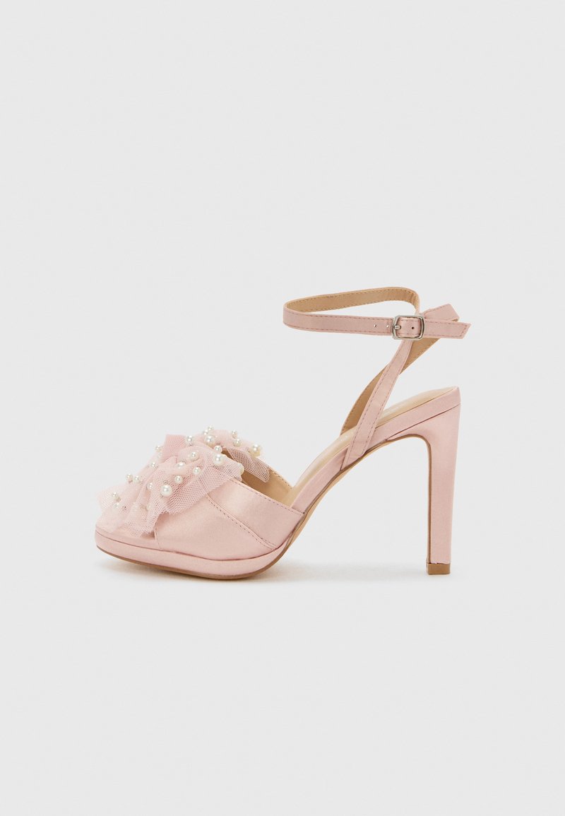 Light pink satin high-heeled sandals with a ruffled tulle detail adorned with faux pearls, featuring an ankle strap and open toe design.
