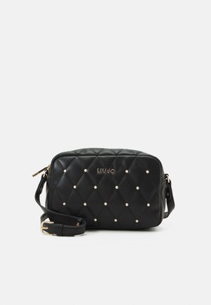 Black quilted leather crossbody bag with small pearl studs, gold buckle, zipper, and "Liu Jo" logo on front.