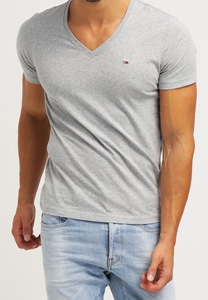 Szara koszulka z dekoltem w serek wykonana z miękkiej bawełny, z krótkimi rękawami i dopasowanym krojem. Małe logo umieszczone po lewej stronie na klatce piersiowej.