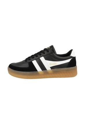 Black and white sneakers with a smooth leather upper, featuring two white stripes, a gold logo, and a translucent gum rubber sole.
