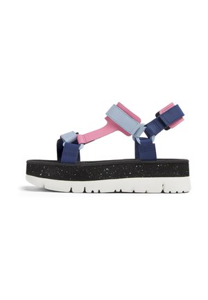 Multi-colored sandals featuring blue, pink, and navy straps with adjustable closures, thick black speckled sole, and white rubber bottom.
