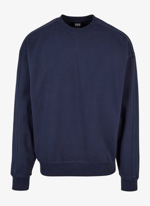 Granatowa bluza crewneck wykonana z miękkiej bawełny. Posiada ściągacze przy mankietach i u dołu, z prostym wzorem i bez dodatkowych ozdób.