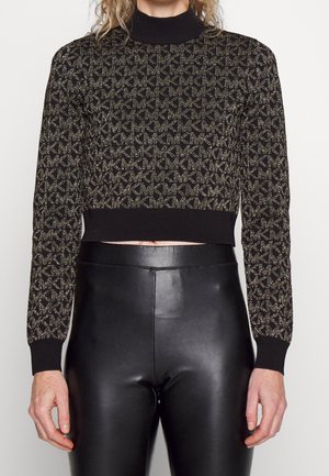 Svart croppad tröja med guld geometriskt mönster, ribbad polokrage och muddar, bärs med högmidjade svarta läderleggings.