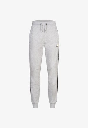 Pantalones de chándal grises confeccionados en una tela suave, con cintura elástica ajustable, puños acanalados y una franjas laterales con un logotipo sutil.