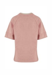 Short-sleeve top, soft pink, velvety texture, crew neck with beige trim, slightly oversized fit, seamless shoulders, no patterns or embellishments.