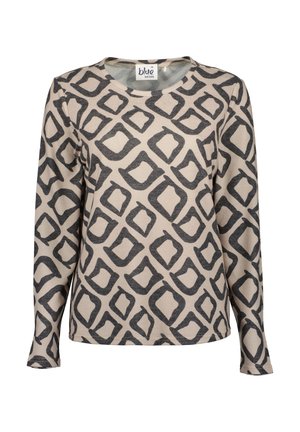Dlouhý rukáv top v krémové barvě s černým geometrickým vzorem, který zahrnuje otevřené čtverce a obdélníky. Vyrobeno z měkkého bavlněného materiálu. Kulatý výstřih.