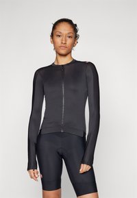 Schwarzes Langarm-Radtrikot mit Reißverschluss vorne, aus leichtem Stretchmaterial. Figurbetontes Design, glatte Textur und kontrastierende Akzente.