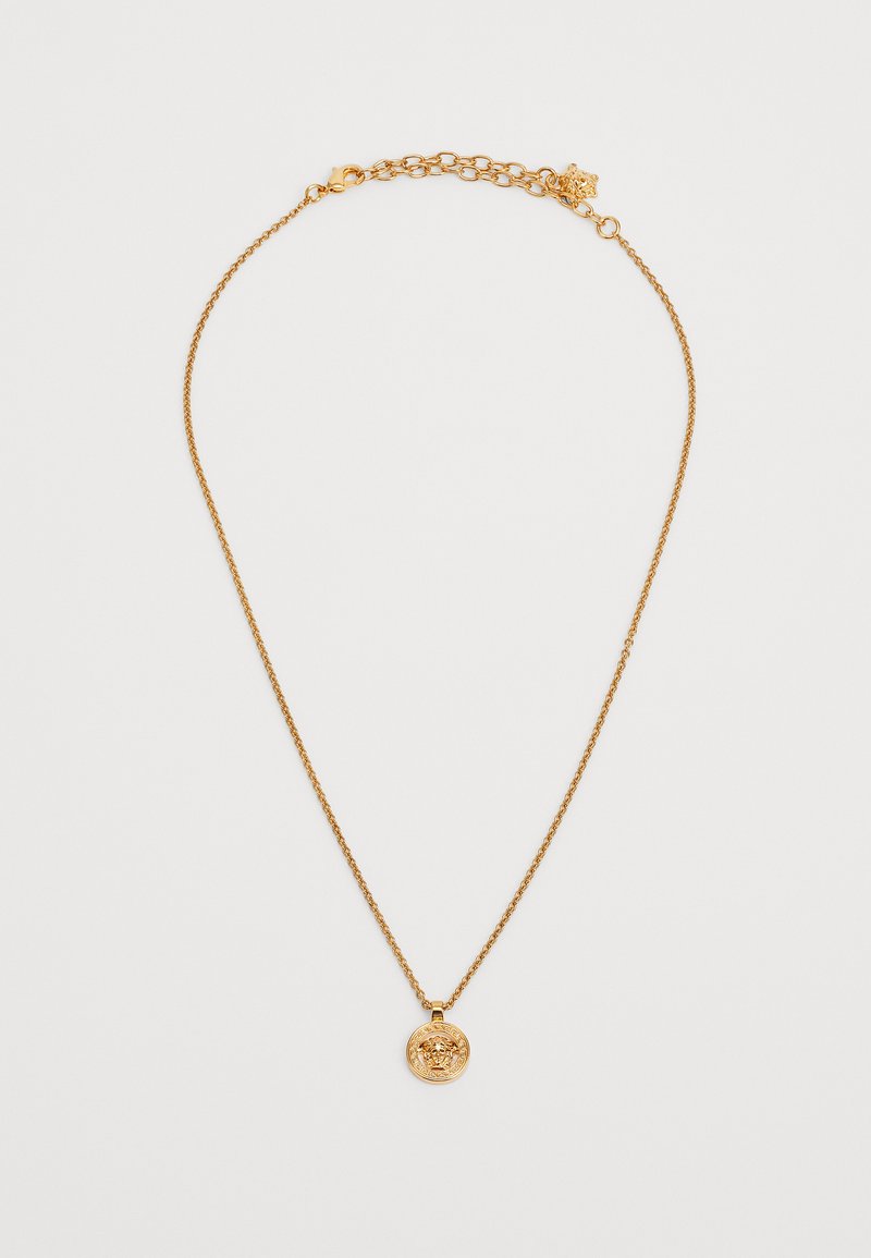 Kuldse tooniga kaelakee peene ahelaga ja ümmarguse ripatsiga, millel on tekstuuriga lõvimotiiv. Reguleeritav lukustus, mis võimaldab erinevaid suurusi.