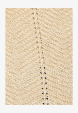 Beige gebreide stof met een visgraatpatroon, gekenmerkt door een fijne textuur en subtiele donkere stippen langs de centrale naad.