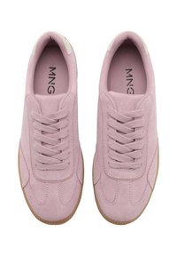 Różowe zamszowe sneakersy o teksturowanym wykończeniu, z zaokrąglonym noskiem, wyściełanym kołnierzem i beżową gumową podeszwą. Sznurówki przechodzą przez pięć oczek.