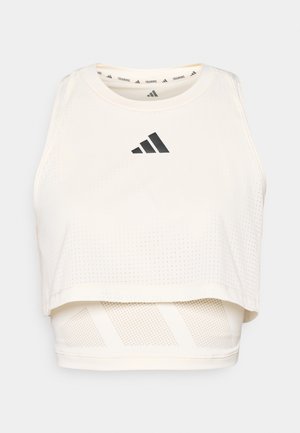 White athletic crop tank top made from breathable fabric. Features a round neckline, perforated texture, and a black logo on the front.