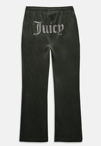 Tmavohnedé sametové tepláky s trblietavým logom "Juicy" na zadnej strane, s rozšíreným strihom nohavíc a elastickým pásom.