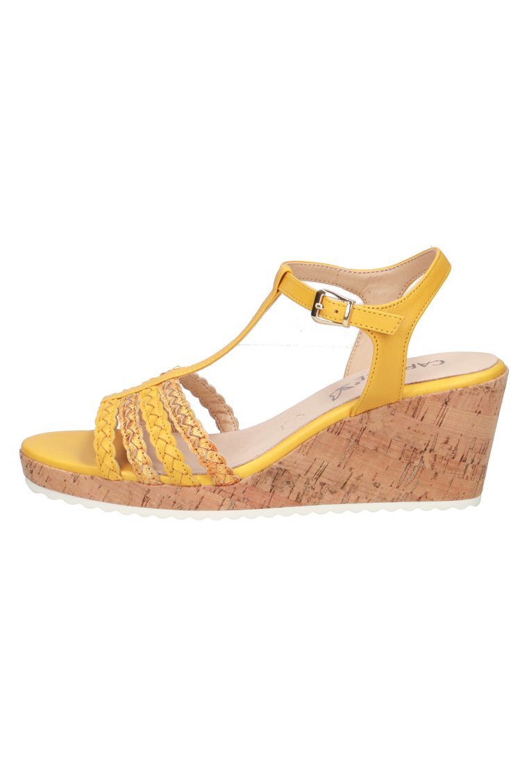 Yellow wedge sandals with braided straps, cork-textured sole, and an ankle buckle. Features a smooth footbed and rubber outsole.