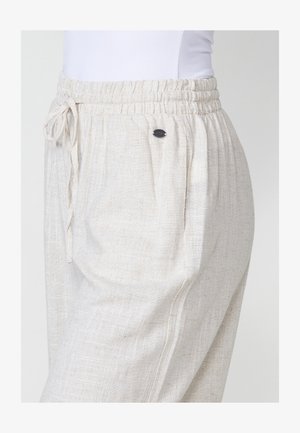 Svetlo béžové nohavice z ľanovej zmesi s elastickým pásom, nastaviteľnou šnúrkou a malým kovovým logom na boku.