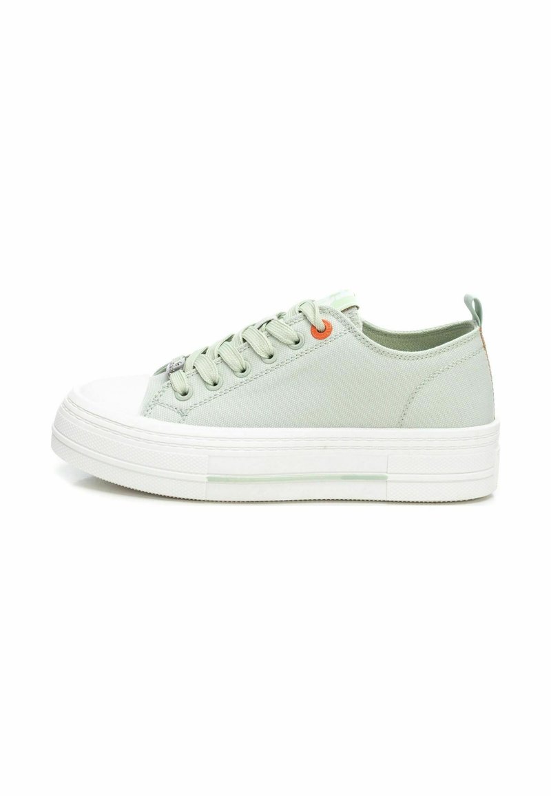 Zapatillas de lona verdes con una puntera de goma blanca, suela plana blanca y ojales naranjas acentuados; presentan un diseño de corte bajo.