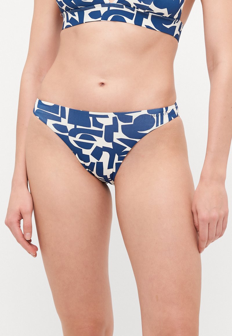 Navy un un krēmu bikini apakšdaļa ar grafisko druku, kurā redzami abstrakti formas. Izgatavota no gludas auduma, tai ir zema vidukļa līnija un minimāla aizsegu.