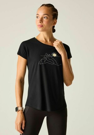 Woman with braided hair wearing a black t-shirt with a mountain and sun line drawing, black leggings, and a smartwatch on her left wrist.