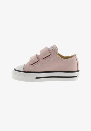 Zapatilla de lona rosa con dos tiras de Velcro, puntera de goma blanca y suela con franjas negras. Presenta paneles laterales texturizados y un interior acolchado.