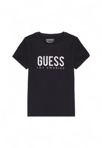 T-shirt nera in cotone con la scritta "GUESS" e "LOS ANGELES" in testo argentato brillante, scollo rotondo standard e maniche corte.