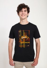 Sort bomulds t-shirt med et grafisk design af en krabbe, med orange og gule accenter, indrammet tekst som siger "NORDPACIFIC."