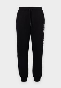TEXT LOGO  - Tracksuit bottoms - black