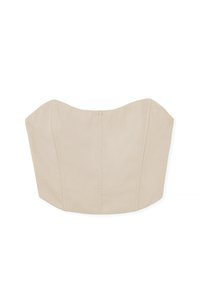 Beige rihmatu topp, millel on struktureeritud ja keha ümber kinnituv disain. Omab kaarekujulisi servi, nähtavaid õmblusi ja sujuvat kangatekstuuri.