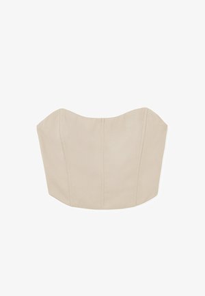 Top sin tirantes color beige con un diseño estructurado y ajustado. Presenta bordes curvados, costuras visibles y una textura de tela suave.