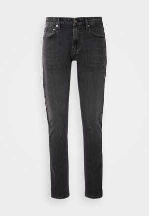 Black denim jeans with a slim fit, five-pocket design, and a button closure. Features classic stitching and a slight fade throughout.