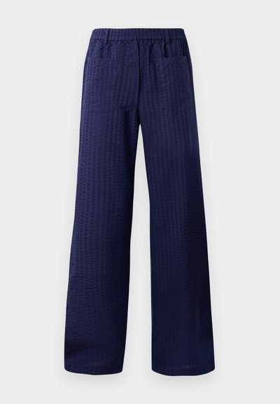 Navy wide-leg pants featuring a textured finish, elastic waistband, and two back pockets. Made from lightweight, breathable fabric.