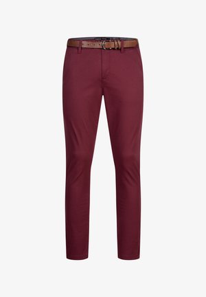 Slim-fit burgundy trousers with a brown leather belt, featuring belt loops and a zip fly closure.