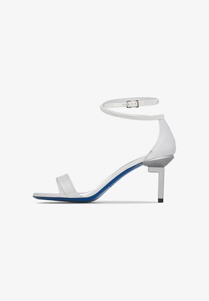 White high-heeled sandal with ankle strap, open toe, and blue sole, featuring a geometric square-shaped heel.
