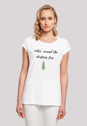 White short-sleeve t-shirt featuring black text "rockin' around the Christmas tree" and a green tree graphic centered below the text.