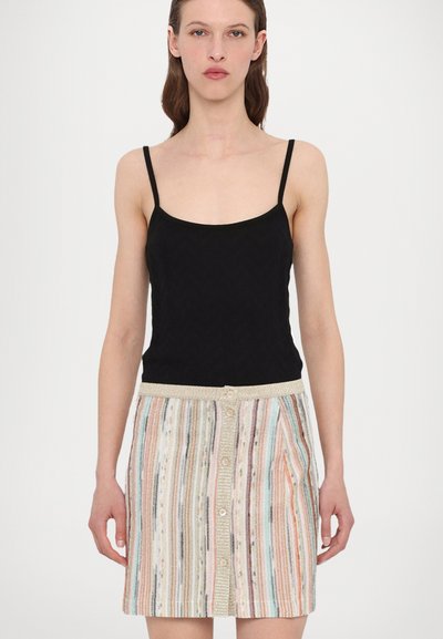 Black tank top with thin straps paired with a multicolored striped skirt featuring textured fabric and button front closure.