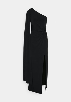 Asymmetrisches schwarzes Kleid aus weichem Stoff, mit design mit einem Schulterträger, verdrehtem Taillendetail und einem Schlitz bis zum Oberschenkel. Lange Ärmeln auf einer Seite.