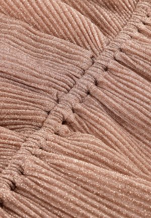 Ribbed fabric in a soft rose gold color with a subtle shimmer, featuring gathered details and textured surface for visual interest.