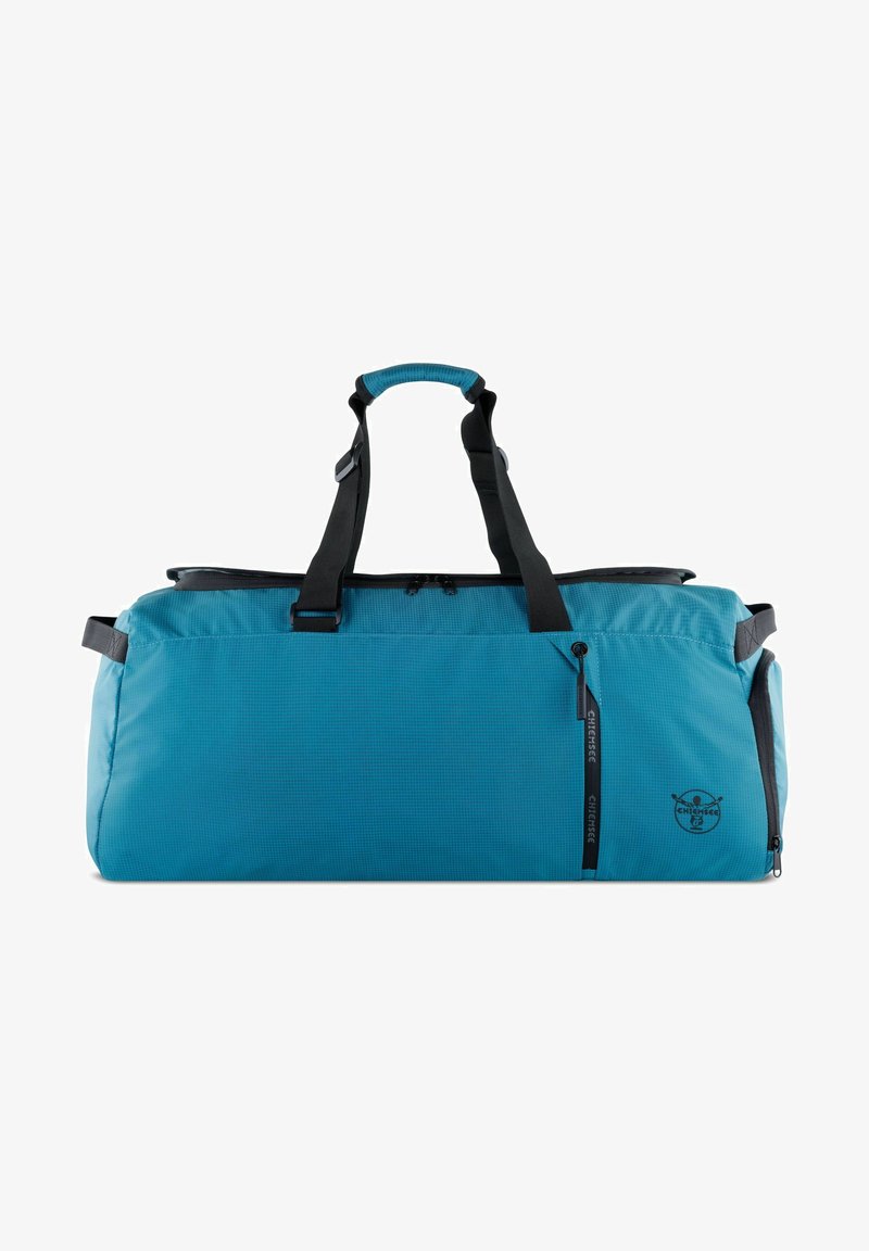 Teal sporttas met een gestructureerd oppervlak, zwarte accenten, dubbele handgrepen aan de bovenkant en een rits zijvak. Heeft een logo op de zijkant.