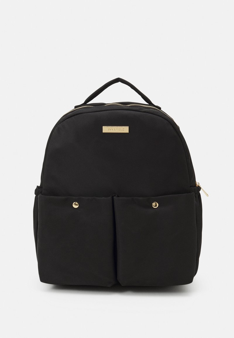 Black nylon backpack with a rounded shape, gold hardware, two front pockets, and a top handle. Features a zip closure and logo plaque.